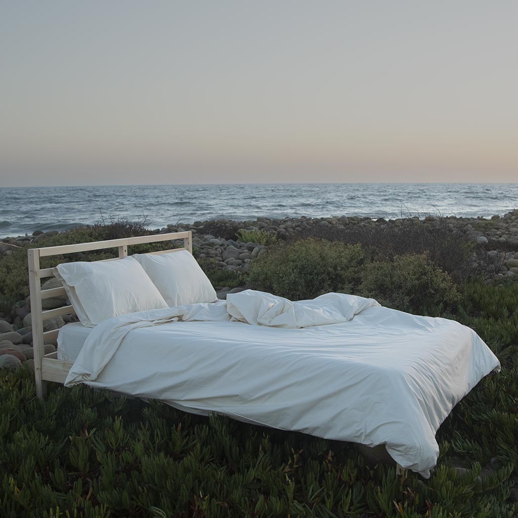 Bed on the beach at sunset.