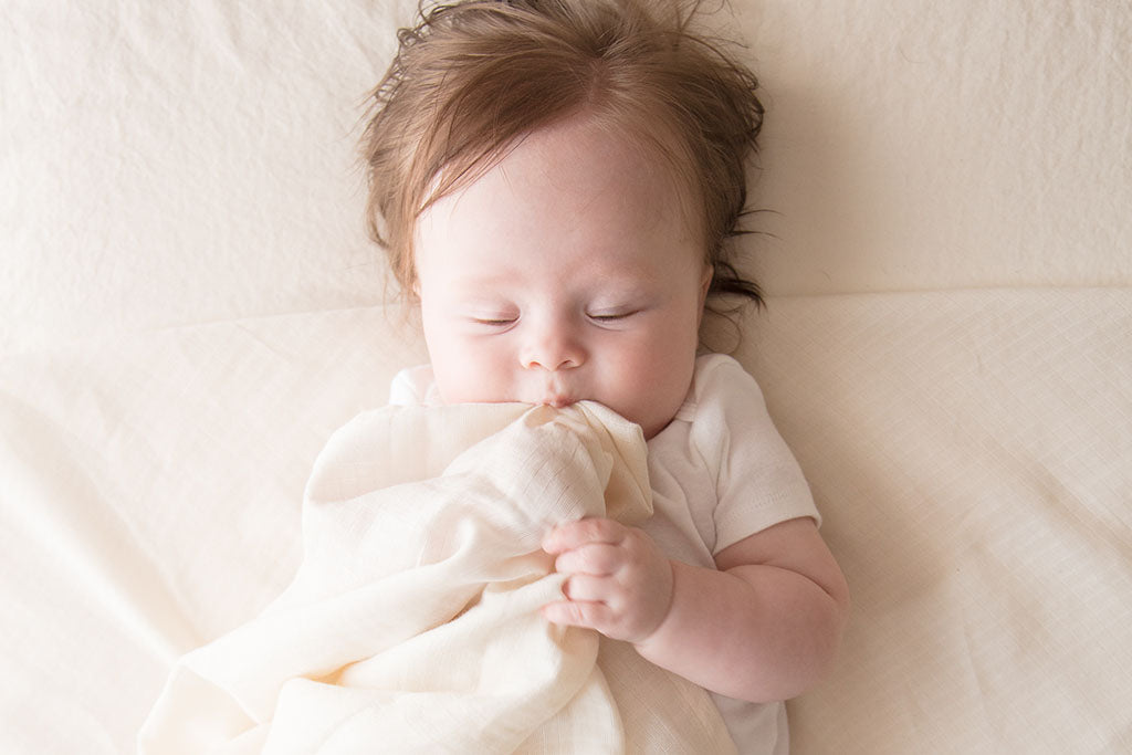 Baby sleeping with swaddle